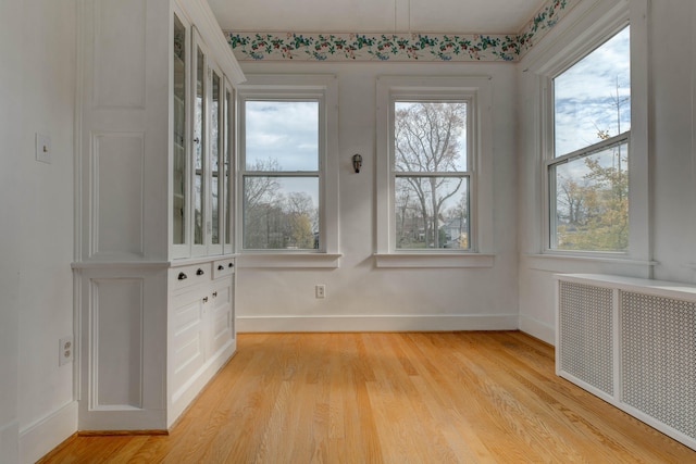 unfurnished sunroom featuring radiator