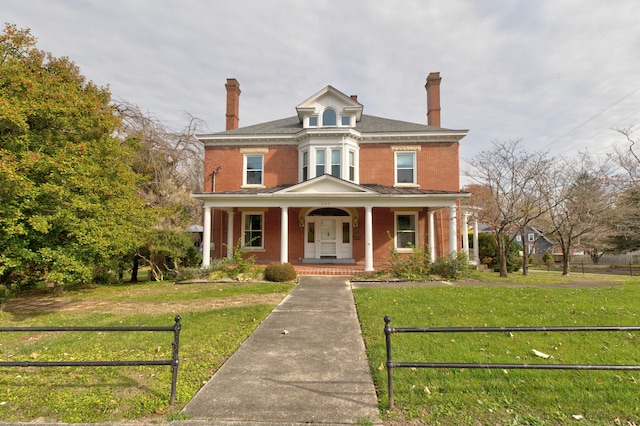 view of front of house featuring covered porch and a front lawn