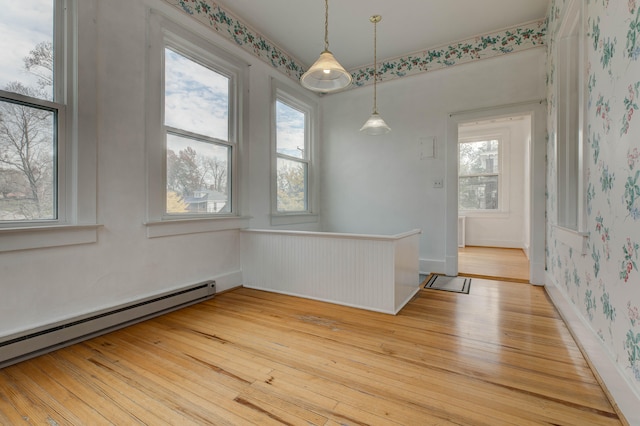 spare room featuring light hardwood / wood-style flooring and a baseboard heating unit