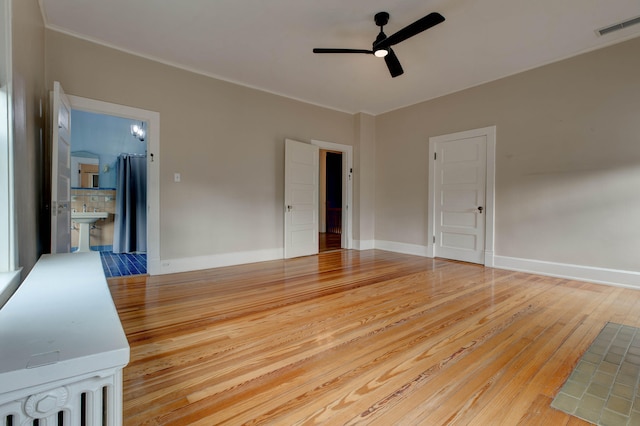 interior space with ceiling fan and hardwood / wood-style floors