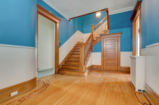 interior space with wood-type flooring and ornamental molding