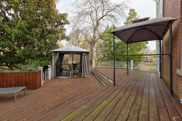 wooden terrace featuring a gazebo