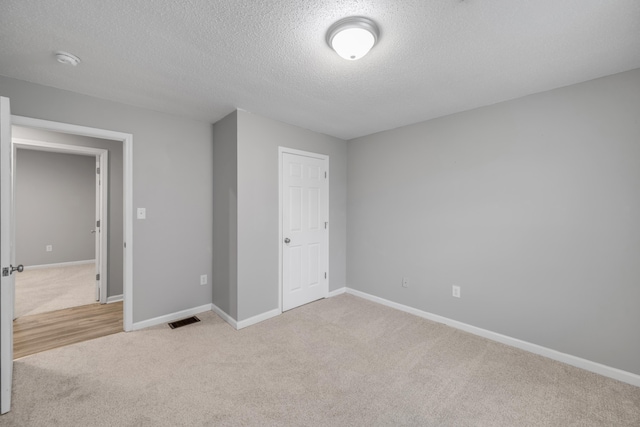 foyer entrance with ceiling fan, light hardwood / wood-style floors, and a textured ceiling