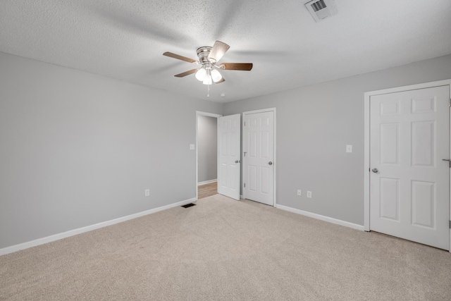 unfurnished room featuring a textured ceiling and carpet flooring