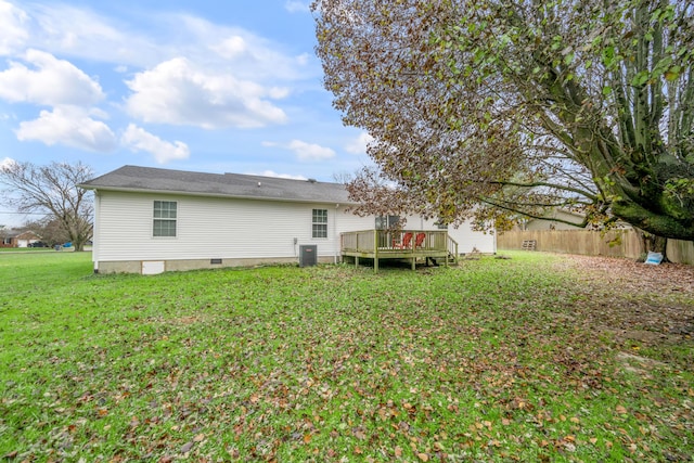 back of property with a yard, a deck, and central air condition unit