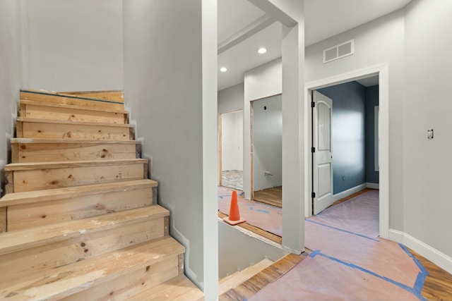 stairway featuring hardwood / wood-style flooring