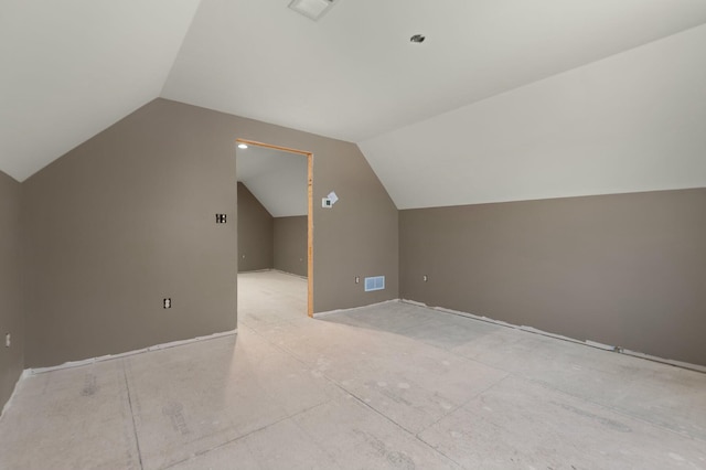 additional living space featuring lofted ceiling