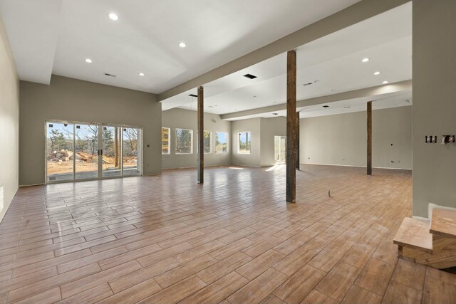 basement featuring plenty of natural light and light hardwood / wood-style floors