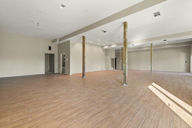 basement with light hardwood / wood-style flooring