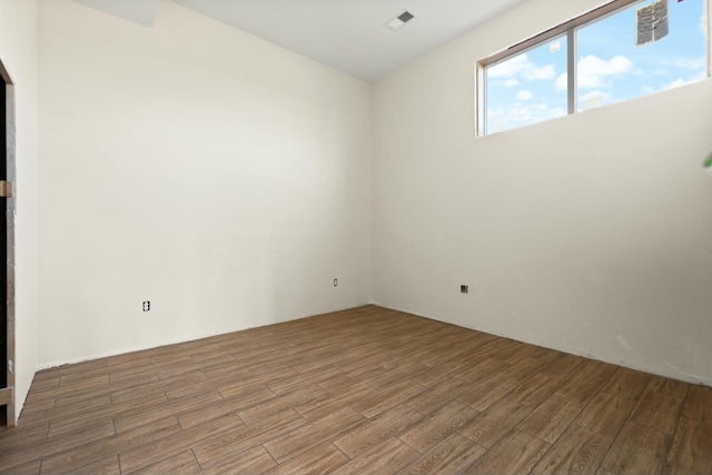 spare room with hardwood / wood-style flooring