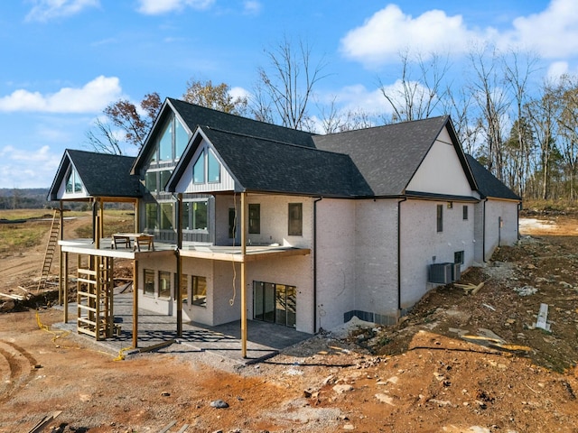 back of property with cooling unit and a patio area