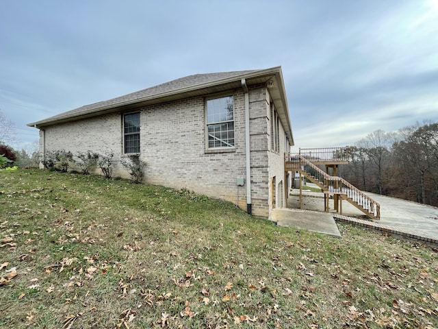 view of side of home featuring a yard