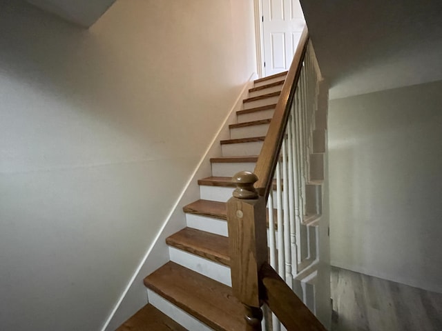 stairs featuring wood-type flooring