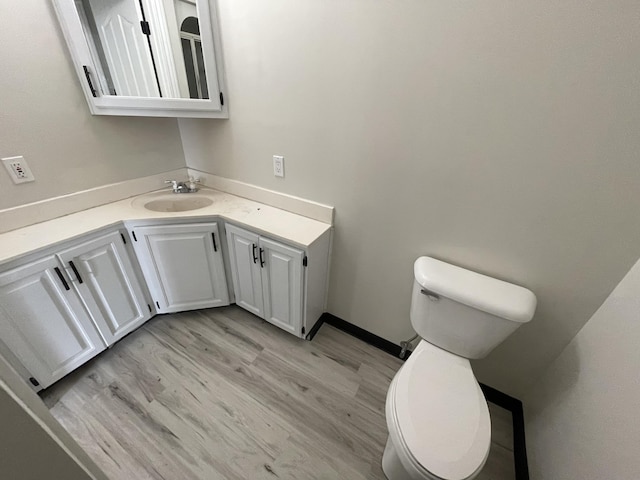 bathroom with vanity, hardwood / wood-style floors, and toilet