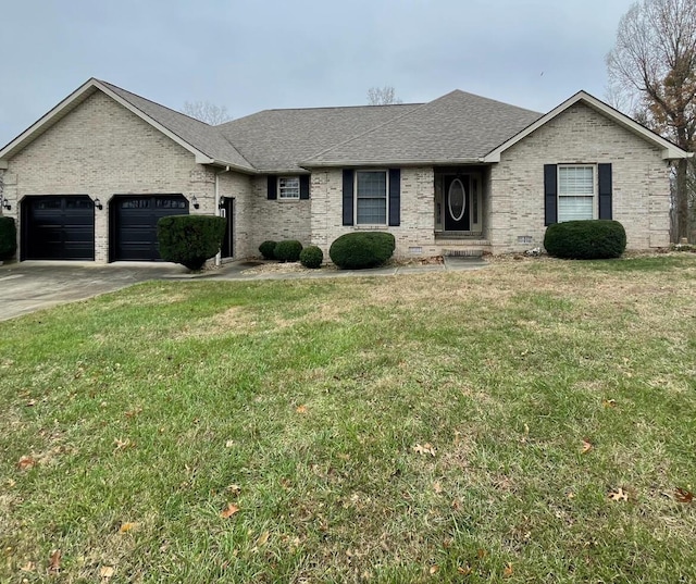 view of front of home with a garage and a front lawn