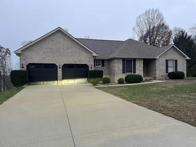 ranch-style house featuring a garage and a front lawn