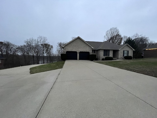 view of front of property with a garage and a front lawn