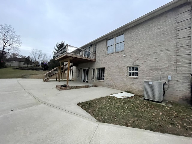 back of property featuring a patio, cooling unit, and a deck