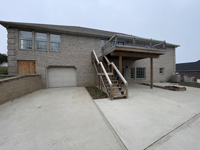 view of front of home featuring cooling unit, a garage, a patio, and a deck