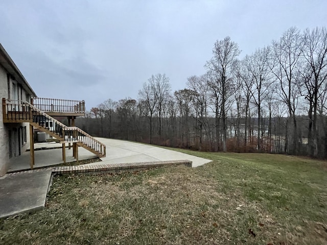 view of yard featuring a wooden deck and a patio area