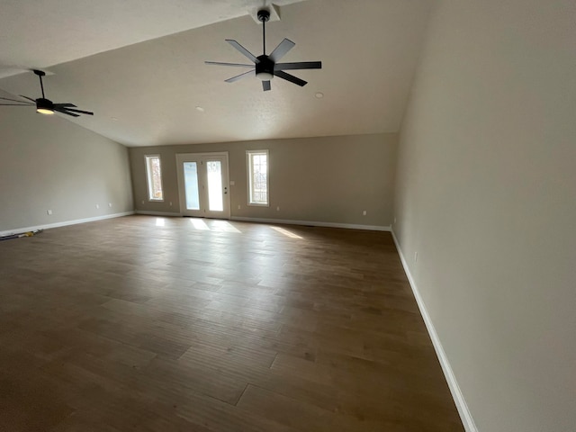 empty room with high vaulted ceiling, dark wood-type flooring, and ceiling fan