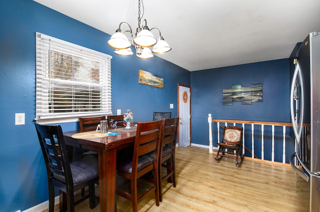 dining space with an inviting chandelier and light wood-type flooring