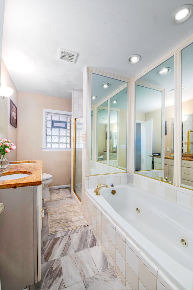 full bathroom featuring separate shower and tub, vanity, and toilet