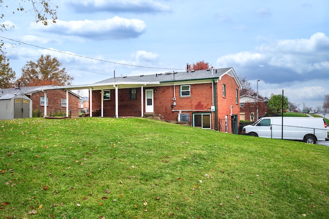 back of house featuring a yard and a shed