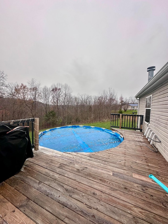 view of swimming pool with a deck