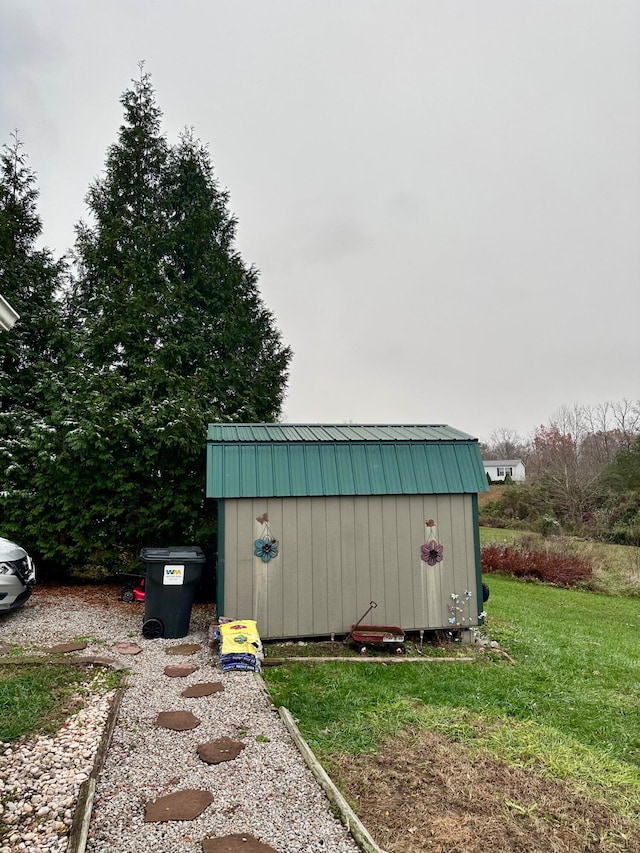 view of outbuilding featuring a lawn