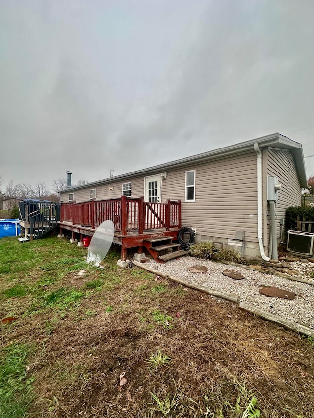 back of property with a wooden deck