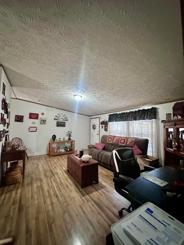 interior space with hardwood / wood-style floors, lofted ceiling, and a textured ceiling