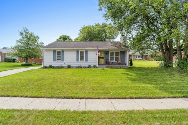 ranch-style home featuring covered porch and a front lawn