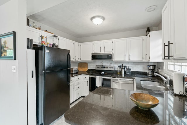 kitchen with white cabinets, decorative backsplash, sink, and appliances with stainless steel finishes