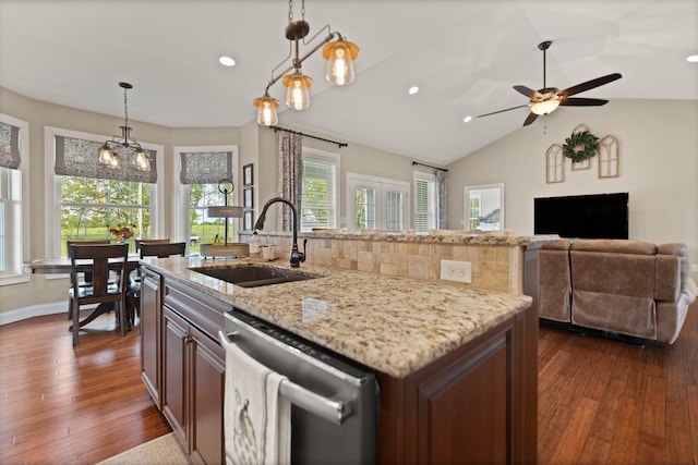 kitchen featuring sink, stainless steel dishwasher, dark hardwood / wood-style floors, lofted ceiling, and a kitchen island with sink