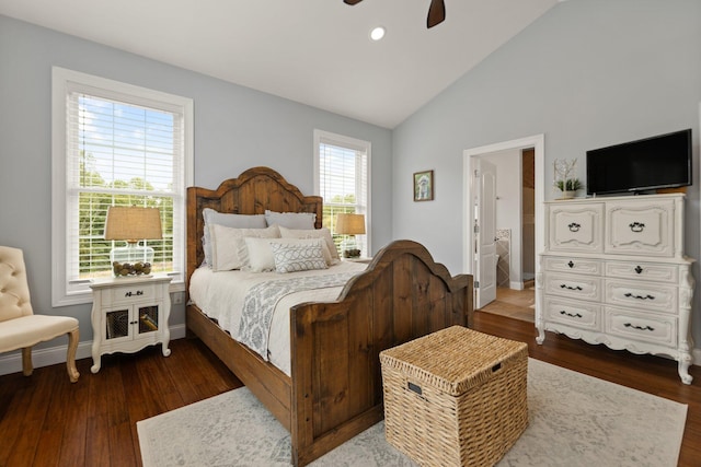 bedroom featuring ensuite bathroom, ceiling fan, dark hardwood / wood-style floors, and high vaulted ceiling