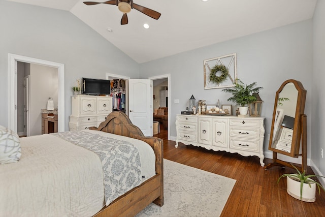 bedroom featuring ceiling fan, dark wood-type flooring, high vaulted ceiling, a walk in closet, and a closet