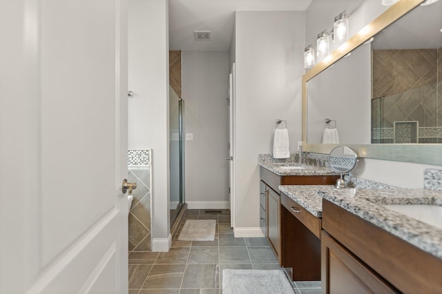 bathroom featuring tile patterned flooring, vanity, and an enclosed shower