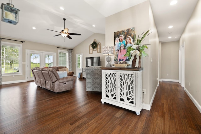 living room with dark hardwood / wood-style floors, ceiling fan, and vaulted ceiling