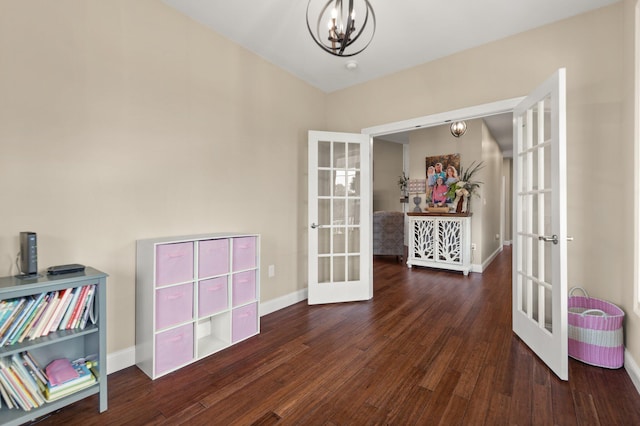 interior space with french doors, a chandelier, and dark hardwood / wood-style floors