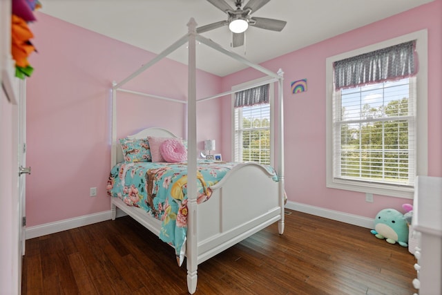 bedroom with dark hardwood / wood-style floors and ceiling fan