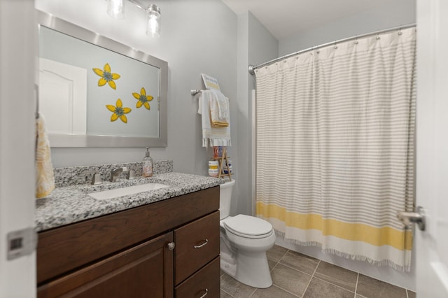 bathroom with tile patterned floors, vanity, and toilet