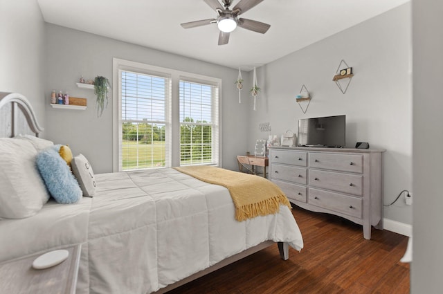 bedroom with ceiling fan and dark hardwood / wood-style floors