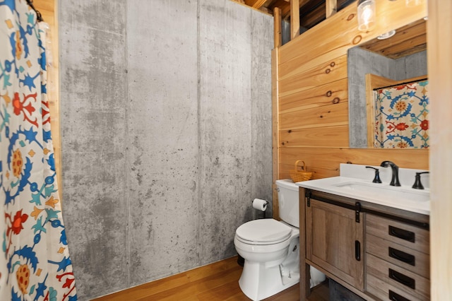 bathroom featuring vanity, hardwood / wood-style flooring, and toilet