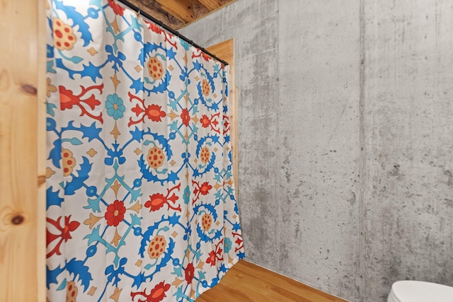 bathroom with toilet and hardwood / wood-style flooring