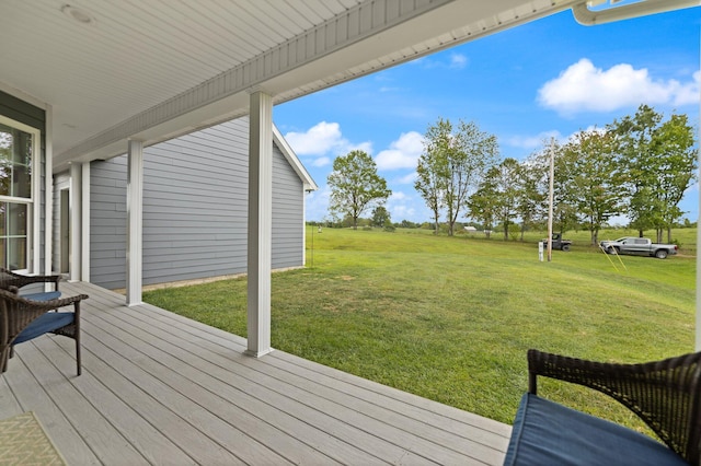 wooden deck featuring a yard