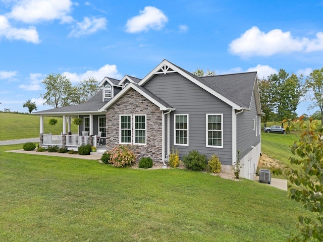 view of front of house with covered porch, a front lawn, and central AC unit