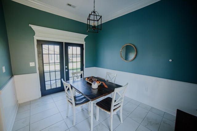 dining area featuring french doors and crown molding