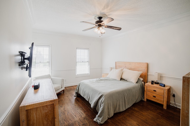 bedroom with a textured ceiling, ceiling fan, crown molding, and dark wood-type flooring