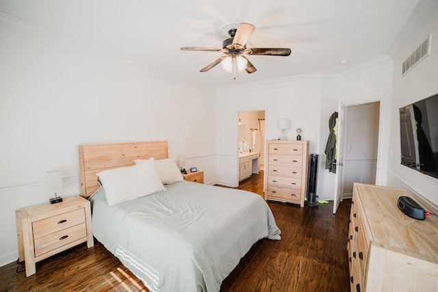 bedroom with dark hardwood / wood-style flooring, connected bathroom, ceiling fan, and ornamental molding